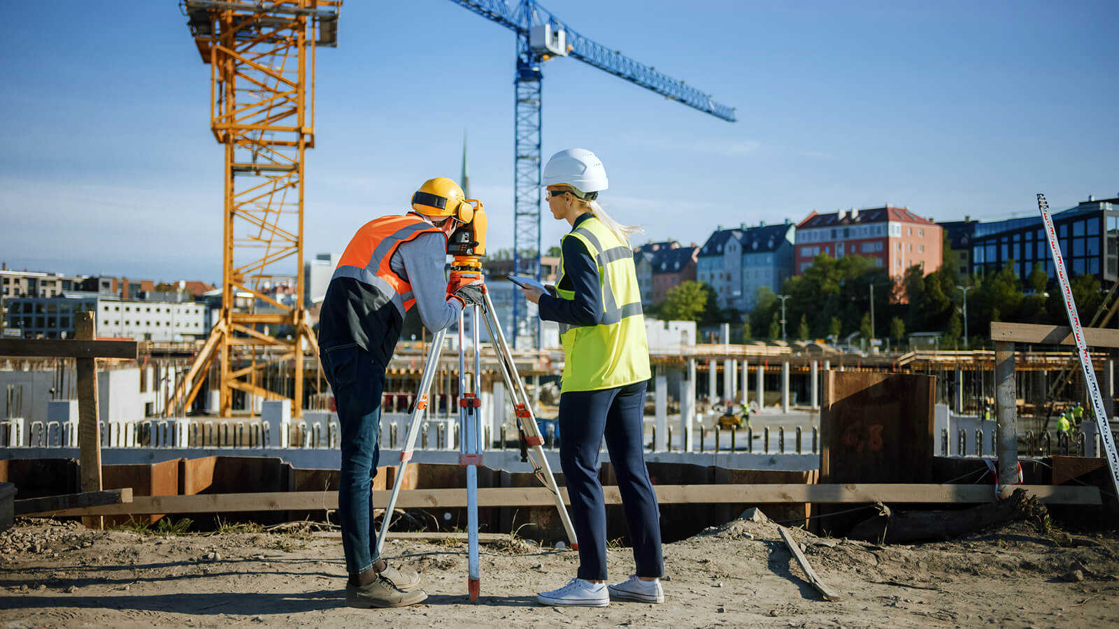 Two surveyors on construction site