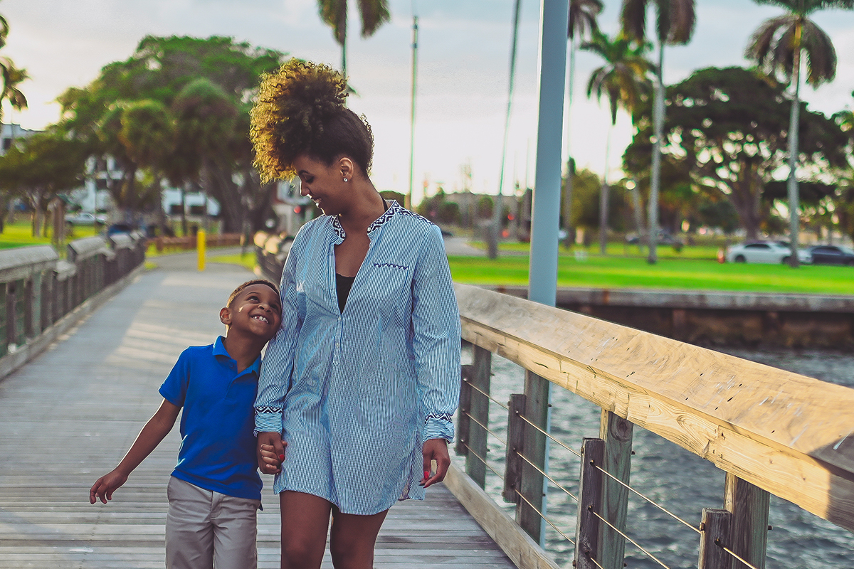 Mother and son walking on pier